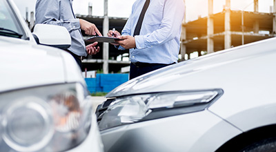 Insurance agent and insured going over paperwork after an auto accident